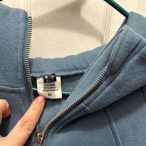 Blue quarter zip sweatshirt. Cropped fit.